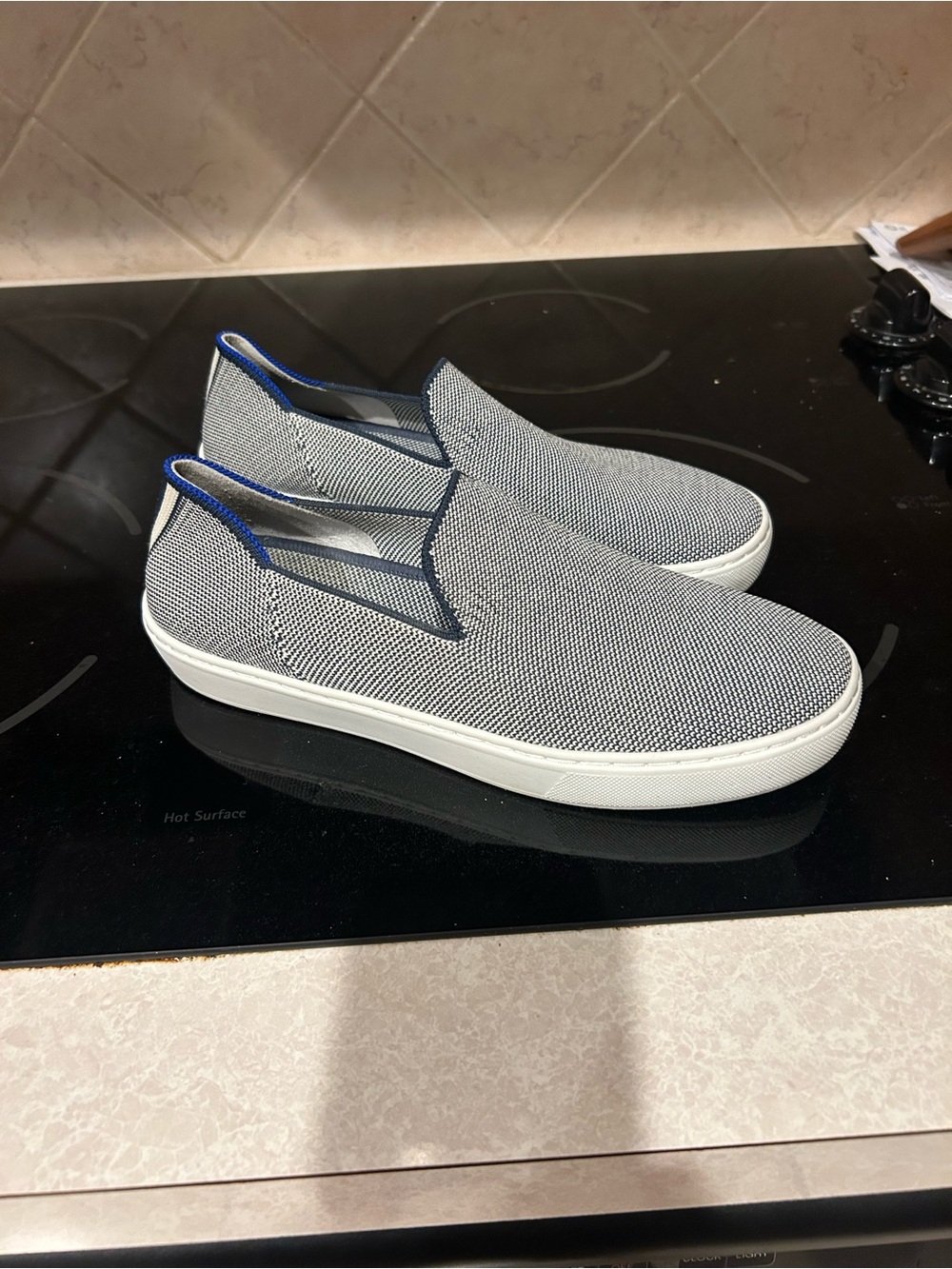 Rothy’s women’s 7.5 Slip-On Knit Sneakers in white and navy